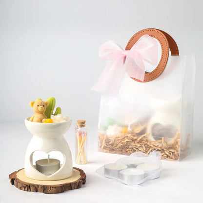 เซ็ตของขวัญแว็กซ์หอมกลิ่นแชมเปญ พร้อมเตาอโรมามินิและเทียนทีไลท์ในถุงของขวัญสีชมพู