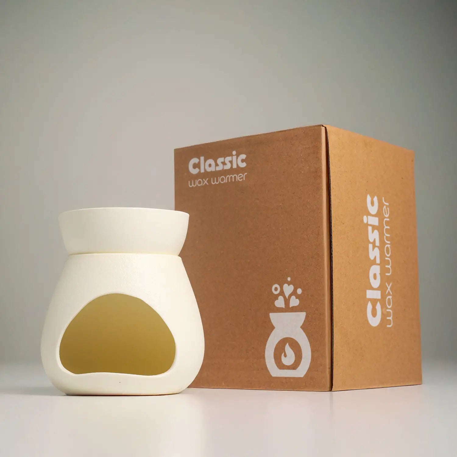 เตาอโรมาเซรามิก รุ่น Signature จาก Dalayla วางคู่กับกล่องบรรจุภัณฑ์ Classic Wax Warmer พร้อมมอบเป็นของขวัญ