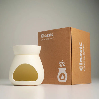 เตาอโรมาเซรามิก รุ่น Signature จาก Dalayla วางคู่กับกล่องบรรจุภัณฑ์ Classic Wax Warmer พร้อมมอบเป็นของขวัญ